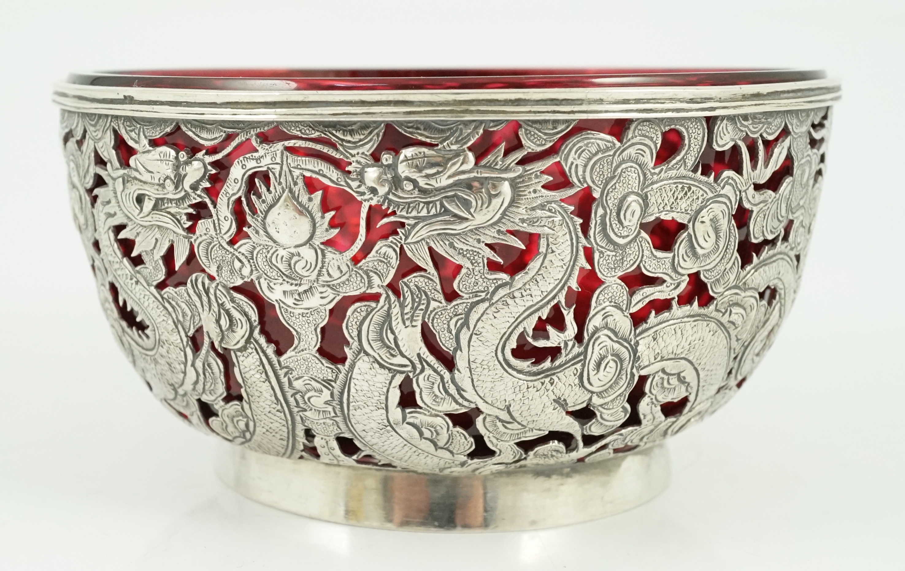 A late 19th/early 20th century Chinese Export pierced silver bowl, by Wang Hing, Hong Kong, with ruby glass liner